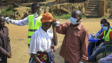 People crossing the border at Kasindi, on the border between Congo and Uganda,   have health checks.