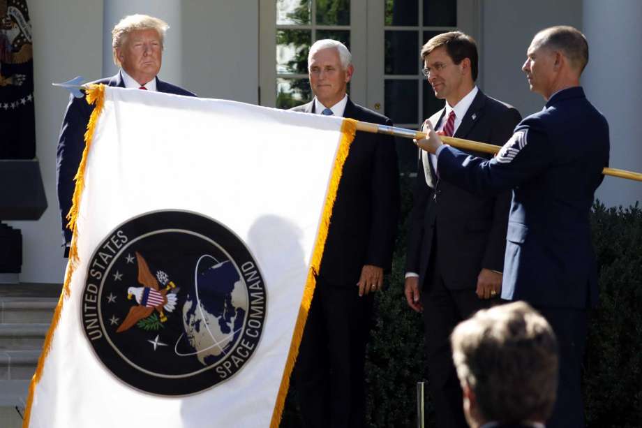 President Donald Trump watches with Vice President Mike Pence and Defense Secretary Mark Esper as the flag for U.S. space Command is unfurled as Trump announces the establishment of the U.S. Space Command in the Rose Garden of the White House in Washington, Thursday, Aug. 29, 2019. Photo: Carolyn Kaster, AP / Copyright 2019 The Associated Press. All rights reserved